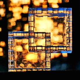 A 12-piece lucite Relativity Box looking through a sunset.