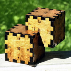 A wooden Relativity Box consisting of two 2-inch cubes that overlap with a 1-inch cube intersection.