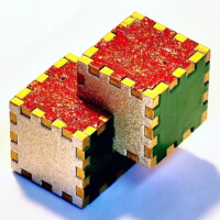 A Relativity Box with the sides painted 3 different colors and golden fingers.